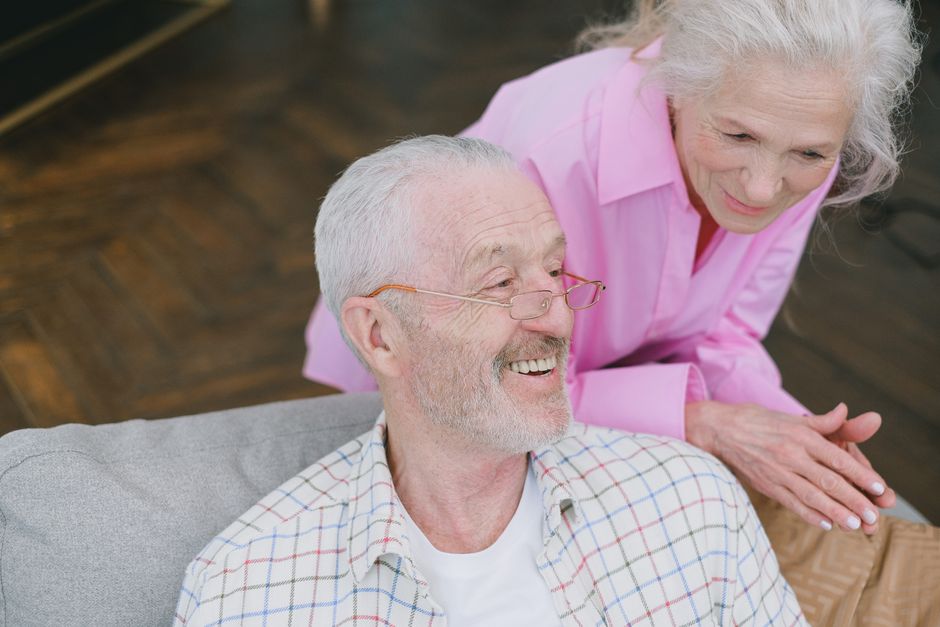 Older couple smiling together at home